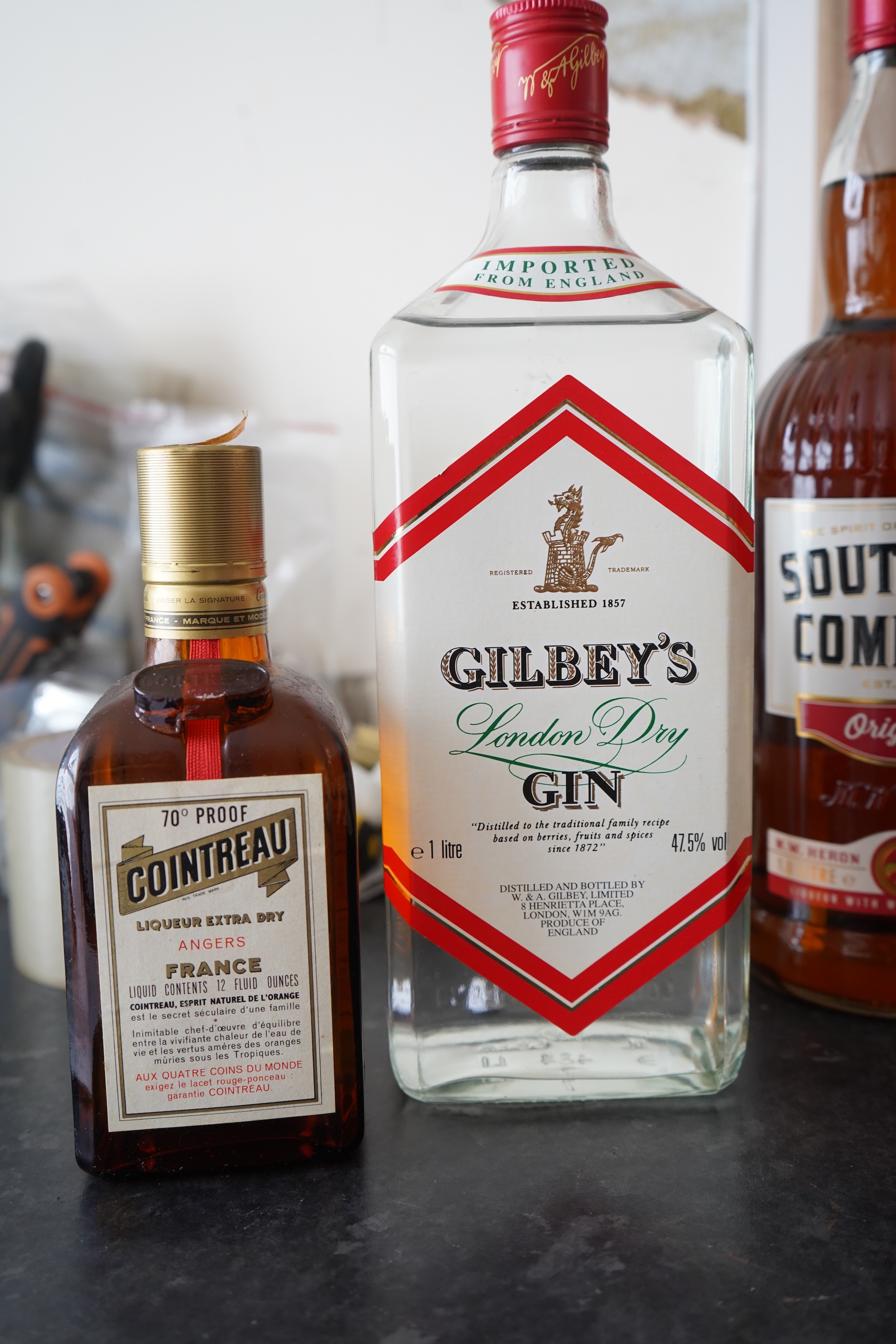 Six bottles of spirits and liqueurs, including whiskey and gin